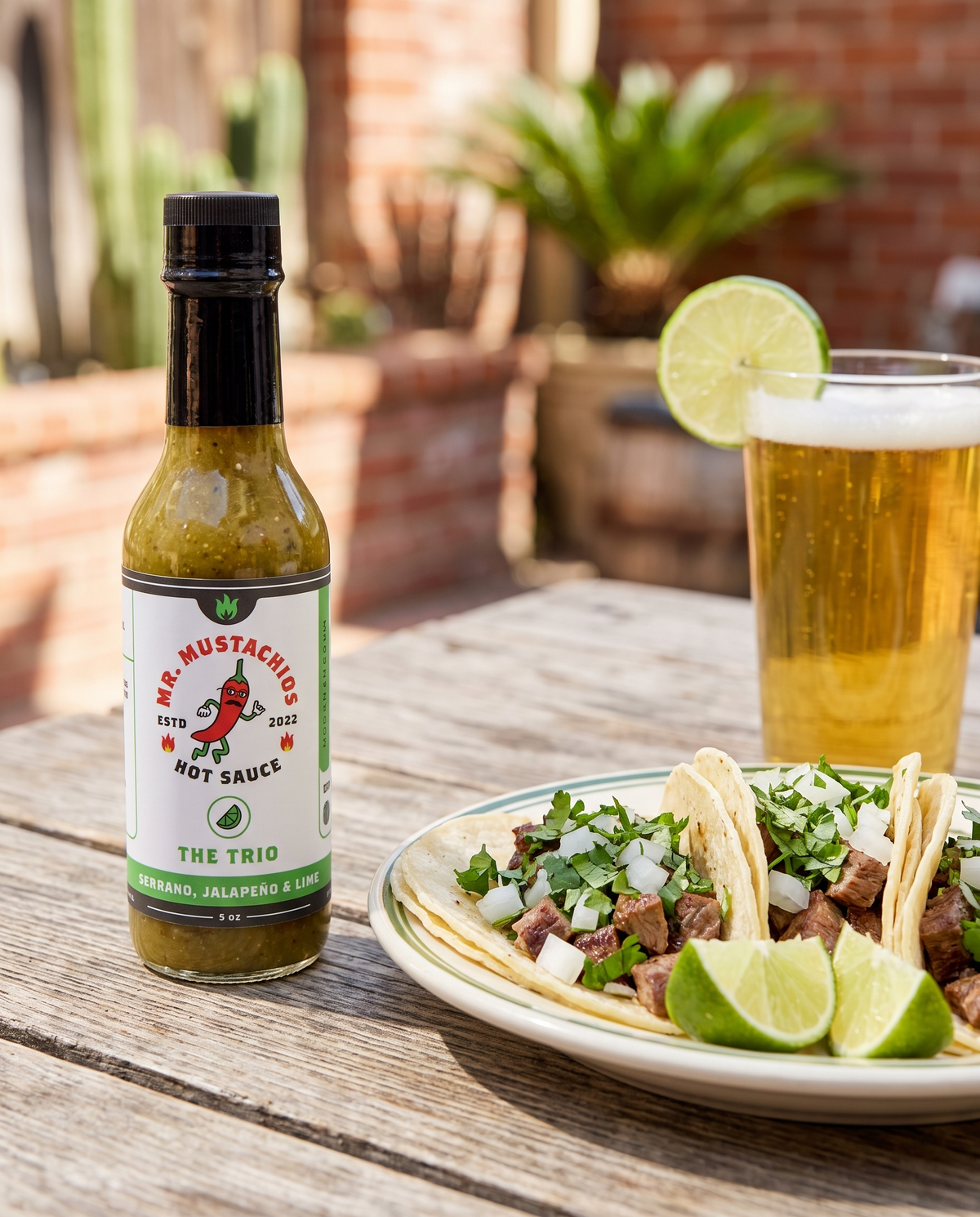 The Trio serrano jalapeño lime hot sauce with carne asada street tacos and a cold lager