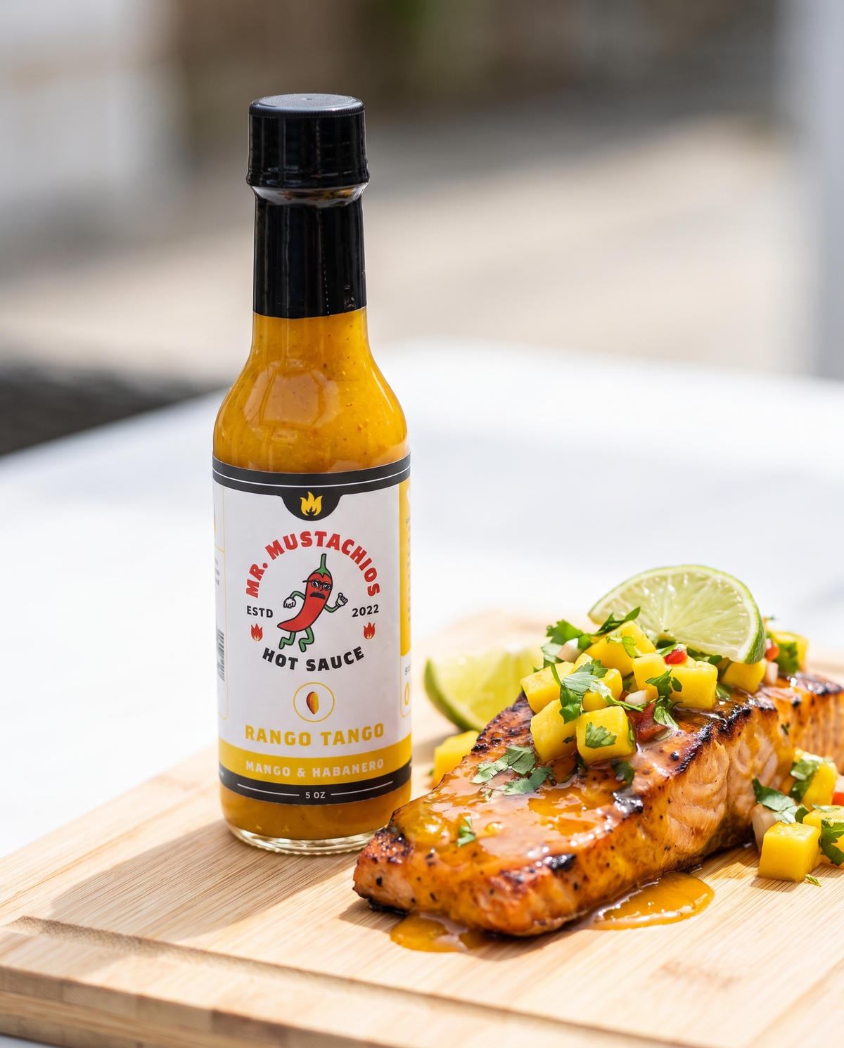 Rango Tango mango habanero hot sauce with grilled salmon and mango salsa